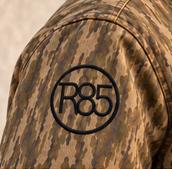 Embroidered R85 circle on a camo jacket shoulder