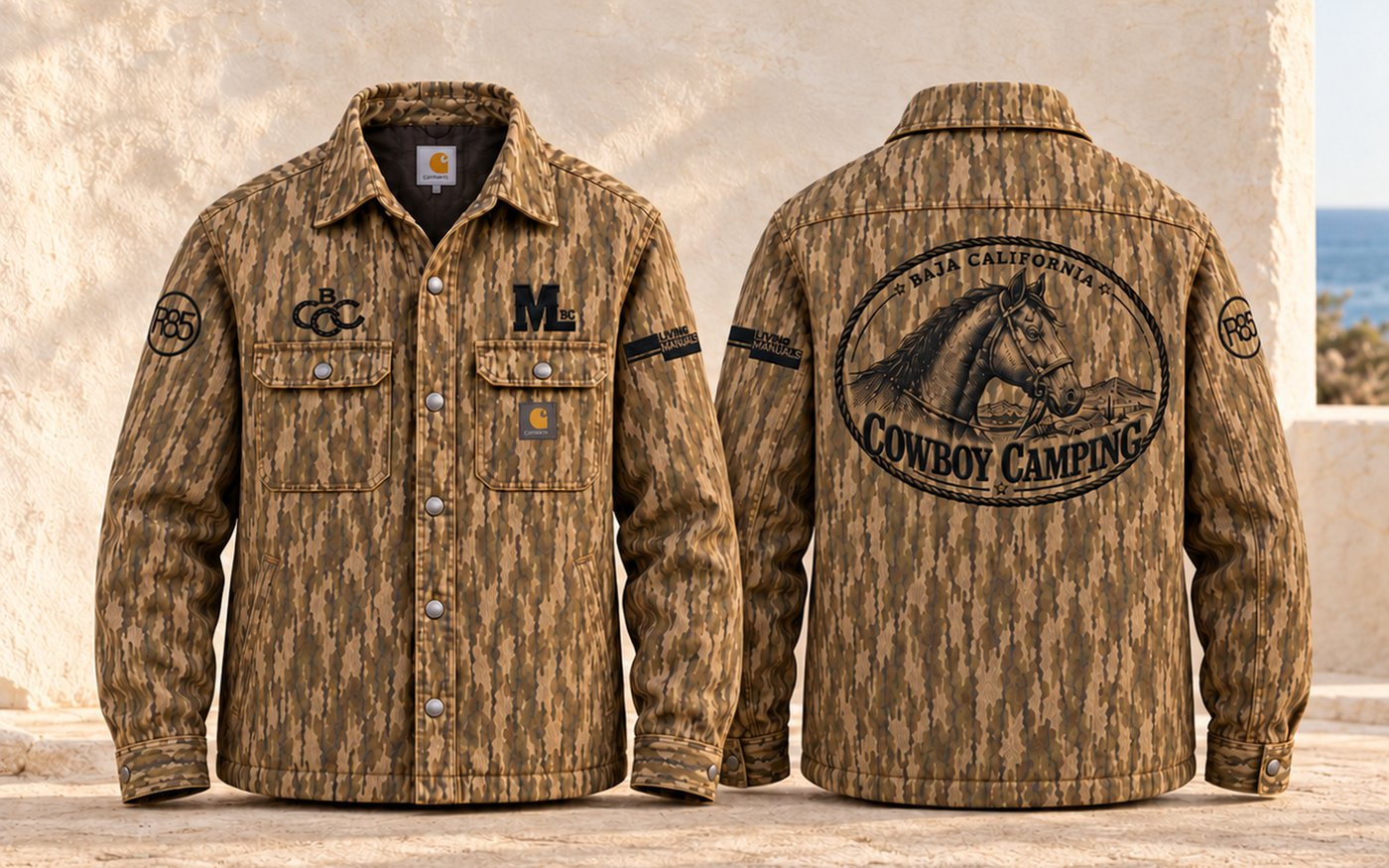 Front and back of a camo Carhartt shirt jac with black embroidery: the BCCC horseshoe monogram and Mud & Lotus on the chest, the Baja California Cowboy Camping horse seal across the back, Rancho 85 and Living Manuals on the sleeves.